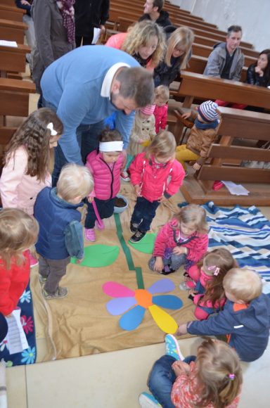 Die Kinder ließen eine bunte Blume auf der Erde wachsen.